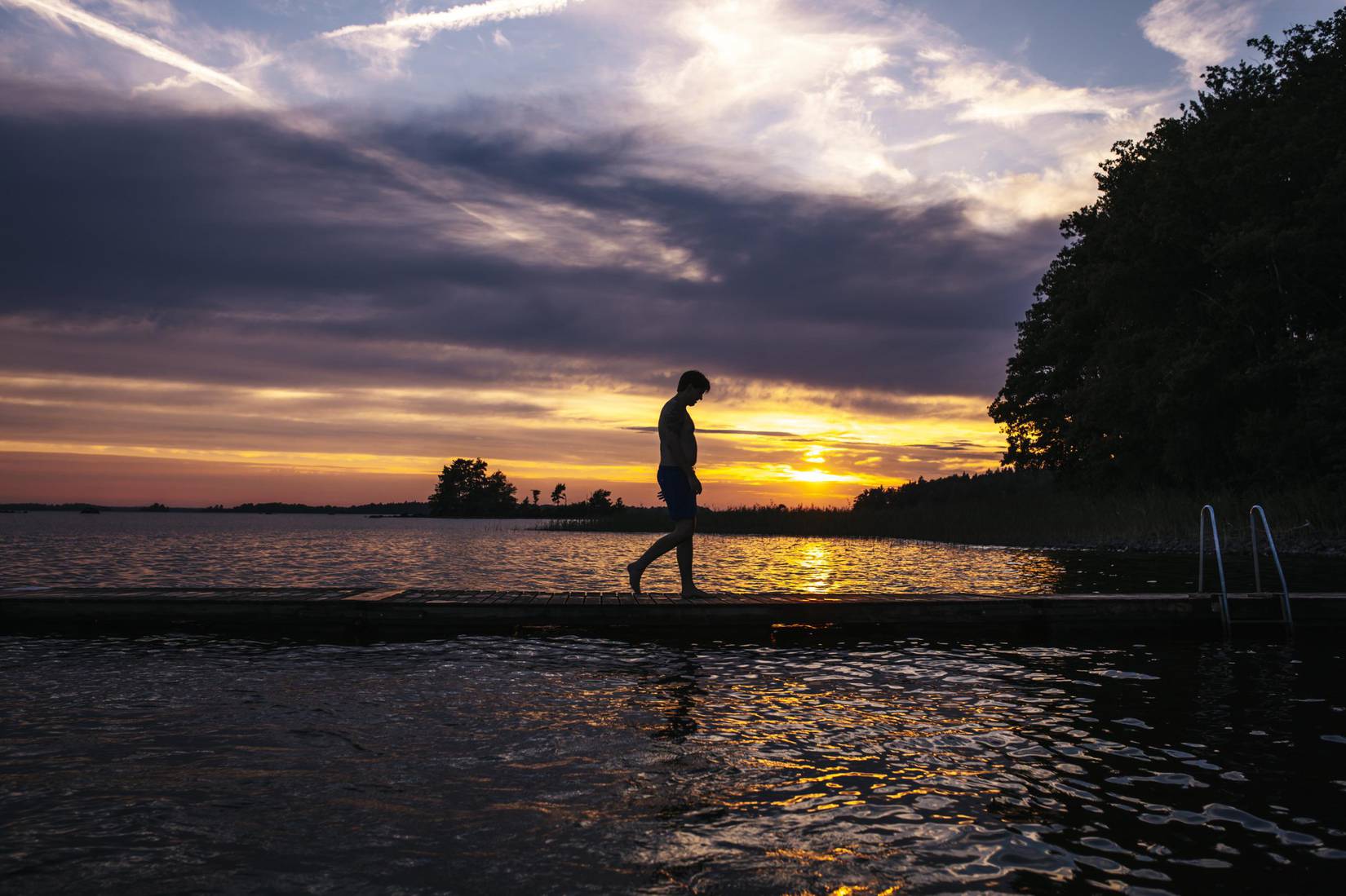 Mid adult man fishing on a lake in Dalarna, Sweden stock photo